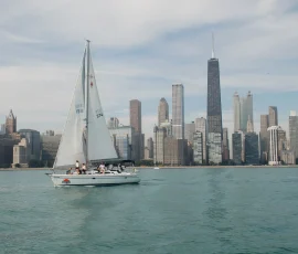 Sailboat charter with full sails against the Chicago skyline